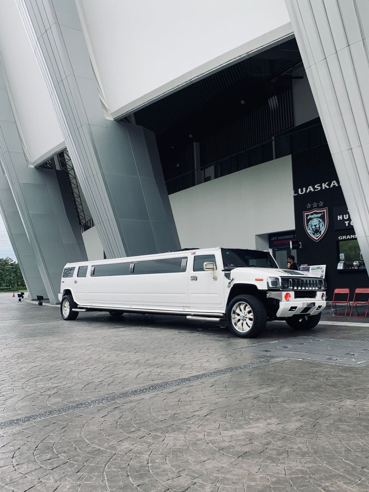 White stretch limousine outside a venue