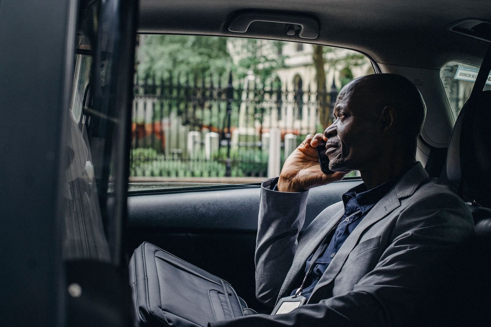 Passenger in the back of a taxi making a phone call